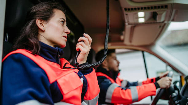 Картината върху платно Rescuers sitting in ambulance, preparing for