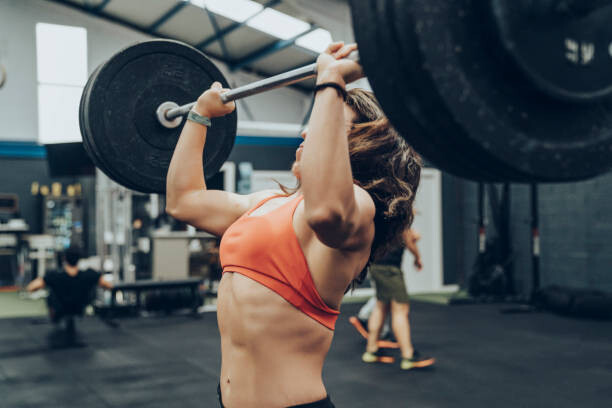 Картината върху платно Unknown strong woman exercising with a bar.