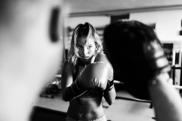 Картината върху платно Woman boxer workout with coach